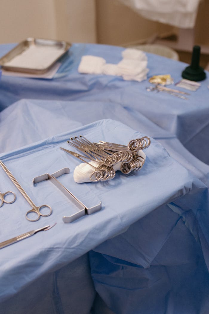 services-02 Close-up of surgical tools arranged neatly on a sterile operating room table.