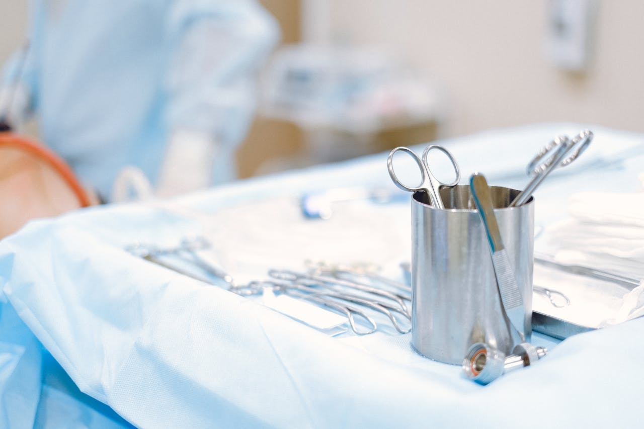 gallery-1 A close-up of surgical instruments on a sterile table in an operating room, emphasizing precision and care.