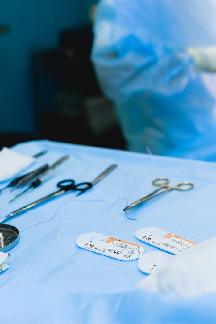 services-01 Close-up view of surgical instruments on a sterile table in an operating room.
