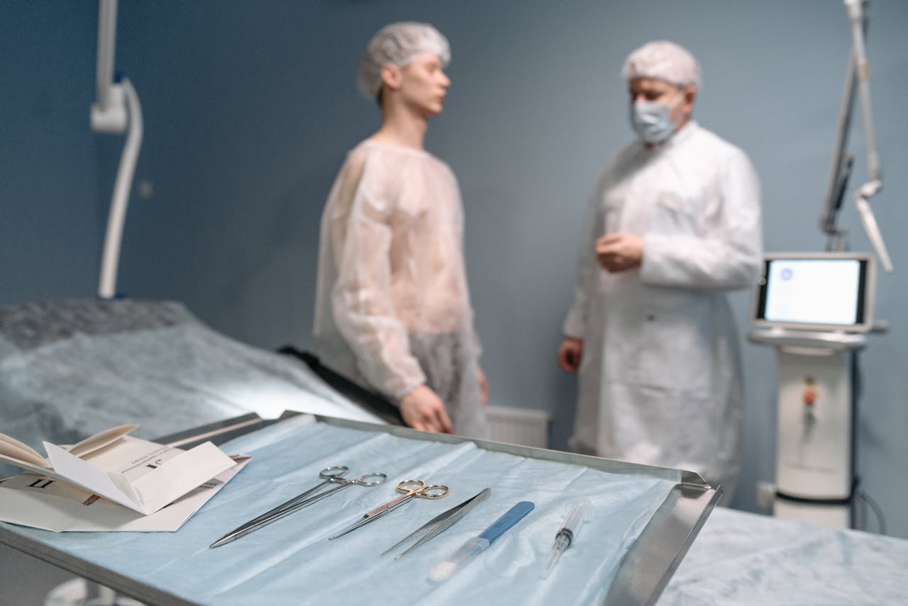 gallery-3 Surgical tools arranged on tray in operating room with doctors in the background.