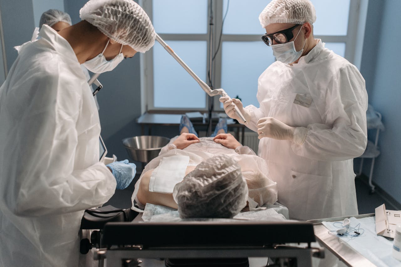 gallery-6 Surgeons in sterile gowns performing surgery in a modern operating room.